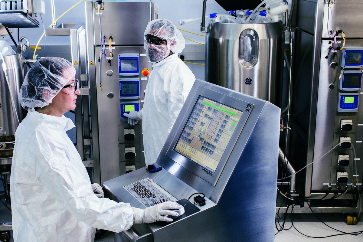 two people in protective gear inside a facility