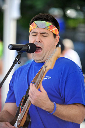 man playing a guitar and singing