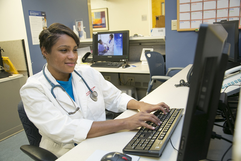 Dr. Kanecia Zimmerman working on a computer