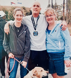 man with wife and daughter and dog