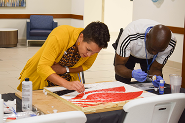 Duke Employees working on the AAPI Mural