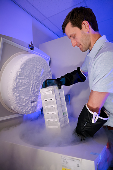 Dr. Hendrickson removing samples from a cryo freezer