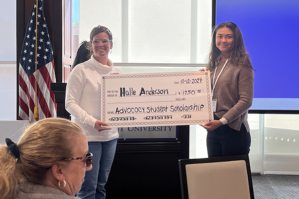 a student being presented a giant novelty check