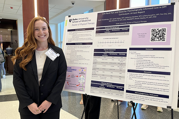 student beside her poster presentation