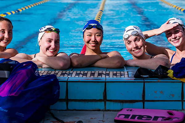 Kyra and four swim teammates in the pool