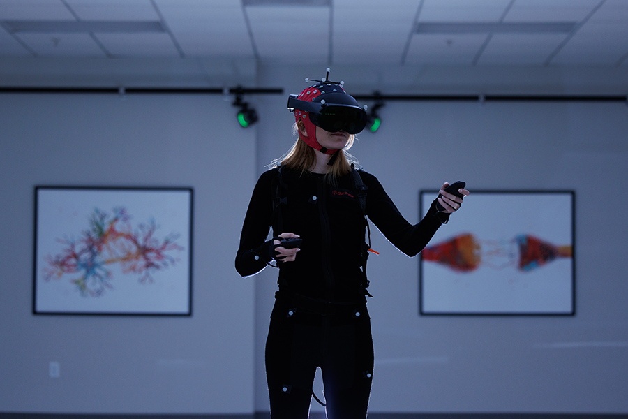 lab member wearing cap and goggles to map the brain.