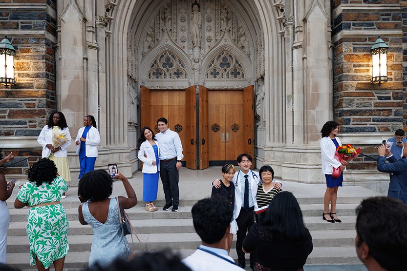 Students and their loved ones pose for photographs in front of the Duke Chapel 