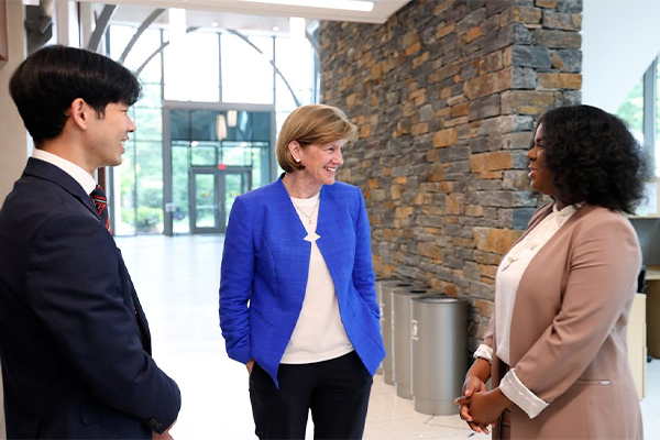 Dean Klotman speaking with Daren Solis and Alvin So, two students enrolled in Duke's health professions programs.