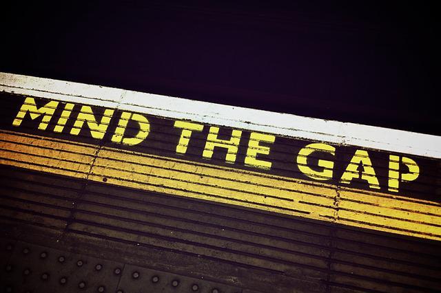Text on subway floor that says "mind the gap"