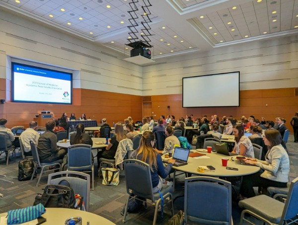 Faculty meet in the Great Hall of the Trent Semans Center